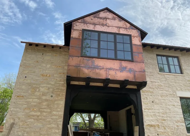 Copper metal panel facade on a stone building for Skylight Installation in Pleasant View